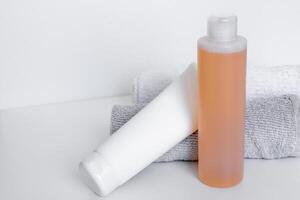 Sleek bathroom essentials with shampoo and body lotion on soft towels in a tranquil setting photo