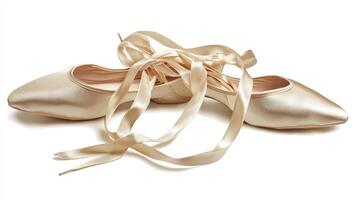 delicate ballet pointe shoes rest on a white surface with soft shadows enhancing the satin ribbons and toe box highlighting their graceful design and significance in dance. photo