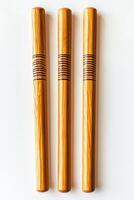 cricket wicket set with bails is elegantly arranged emphasizing the rich wood grain and subtle shadows in a minimalist composition. The bright lighting highlights the details beautifully. photo