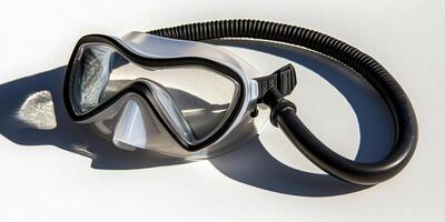 diving snorkel and mask set rests on a white surface highlighting a silicone mask paired with a flexible breathing tube under bright lighting and soft shadows. photo