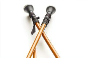 pair of ski poles is crossed in a minimalist style focusing on the grips and tips softly casting shadows below. The lighting highlights the sleek design of the accessories. photo
