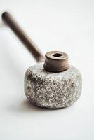 curling stone rests on a white background showcasing its polished granite and distinctive handle. Soft shadows create a minimalist feel emphasizing the sports equipment. photo