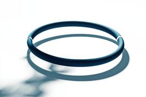 gymnastic hoop sits elegantly on a bright white background showcasing its shiny metallic surface and soft shadows. The studio lighting enhances its artistic appeal. photo