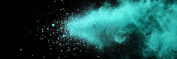 A vibrant explosion of turquoise particles surges outward, radiating energy and creating a stunning display of light on a black background, evoking a sense of movement and power. photo