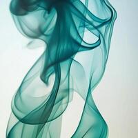 Turquoise smoke elegantly ascends, its wisps intertwining and fading into transparency, showcasing a mesmerizing dance of color and movement. photo
