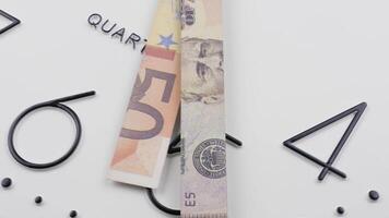 Time and money. Clock face timelapse with rotating arrows in the form of a US dollar and Euro banknotes. video