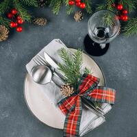 New Year's festive table setting with cutlery and decorations. photo