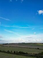 High Angle View of British Agricultural Farms at Streatley Village and Countryside Landscape of Bedfordshire, England Great Britain of UK. Footage Was Captured with Drone's Camera on October 7th, 2024 photo