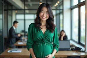 pregnant woman standing and working a her office photo