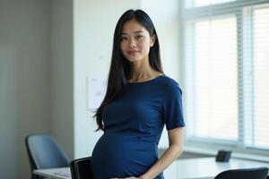 pregnant woman standing and working a her office photo