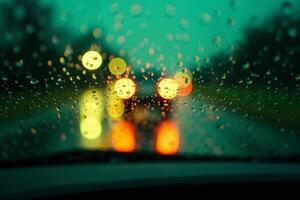 windscreen of car with rain drop water at night photo