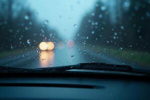 windscreen of car with rain drop water at night photo