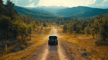 the car drives through the forest on the background of the mountains photo