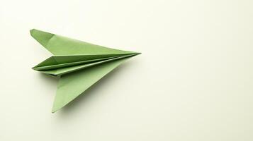 A top-down view of a verdant paper aircraft on a light backdrop photo