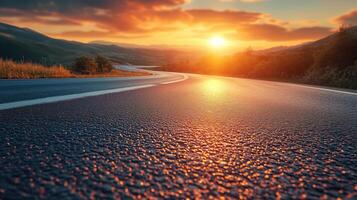 Road in the middle of asphalt road at sunset photo