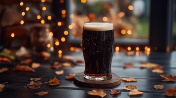Pint of dark beer on wooden coaster, warm fairy lights photo