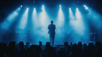 Popular singer on stage in front of crowd on scene in night club photo