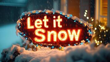 A glowing Let it Snow sign surrounded by snow and festive lights photo