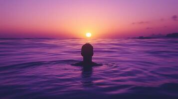 Person Swimming in Purple Ocean at Sunset photo