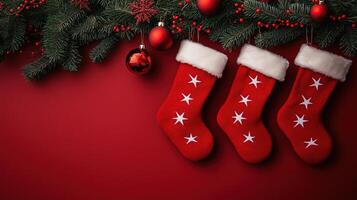 Red Christmas stockings with white stars hang on a pine branch photo