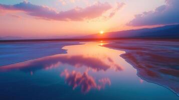 Salt Flats and Pools at Sunset with Pink and Blue Reflections in Water photo