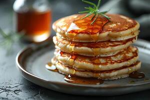 Delicious Stack of Pancakes with Maple Syrup Drizzle for Breakfast Delight photo
