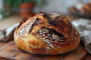 Artisan Sourdough Bread on Rustic Wooden Board for Bakery Design photo