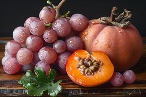 Fresh Autumn Harvest Grapes and Persimmons with Dew Drops on Rustic Board photo