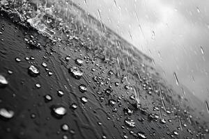 Dynamic Raindrops on a Glass Surface in Black and White for Artistic Design photo