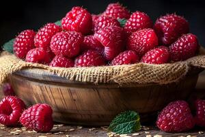 Fresh Raspberries in Rustic Wooden Bowl with Burlap for Natural Harvest Concept photo