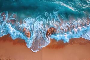 An aerial view of waves crashing into the ocean photo