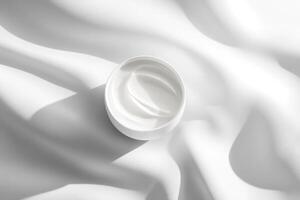 A white container of cream on a white background photo