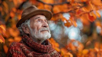 An old man in a hat and sweater looking up at the sky photo