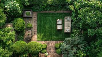 An aerial view of a garden with a lawn, trees and a patio photo