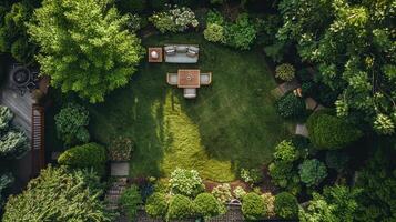 An aerial view of a green garden with a lawn and a table photo