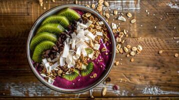 A bowl of fruit and nuts on a wooden table photo