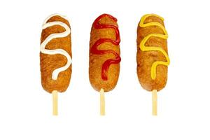 Corn dogs with different fillings and different sauces. isolated on background. photo