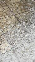 Street tiles wet from rain. Different textures of stone. Large drops and puddles photo