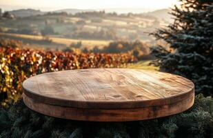 Beautiful wooden table adorned with pine cones overlooks a stunning vineyard landscape at sunset photo