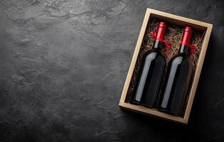 Elegant wooden box containing two wine bottles with red corks on a textured dark surface photo
