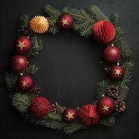 Spherical red ornaments and festive stars arranged in a Christmas wreath on a dark background photo