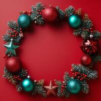 Decorative holiday wreath with colorful ornaments and festive accents on a red background photo