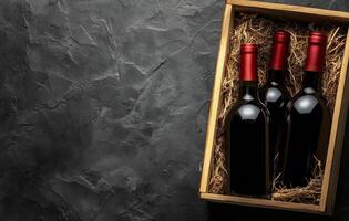 Elegant wooden box containing two wine bottles with red corks on a textured dark surface photo