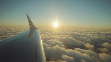 Aerial view of a plane wing above fluffy clouds at sunset during a scenic flight photo