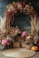Autumn floral arch with dried flowers and decorative elements in warm tones photo