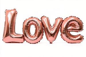 Shiny rose gold balloons spelling love arranged for a celebration or special occasion photo
