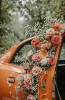 A vintage orange car adorned with colorful flowers parked in a lush green setting during golden hour photo