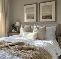 Cozy bedroom featuring soft bedding and peaceful artwork in a serene, neutral toned setting photo