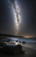 Starlit beach view with the Milky Way above, captured during a clear night by the ocean photo