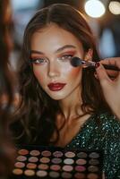 Makeup application on a model during a beauty shoot in a professional studio setting photo